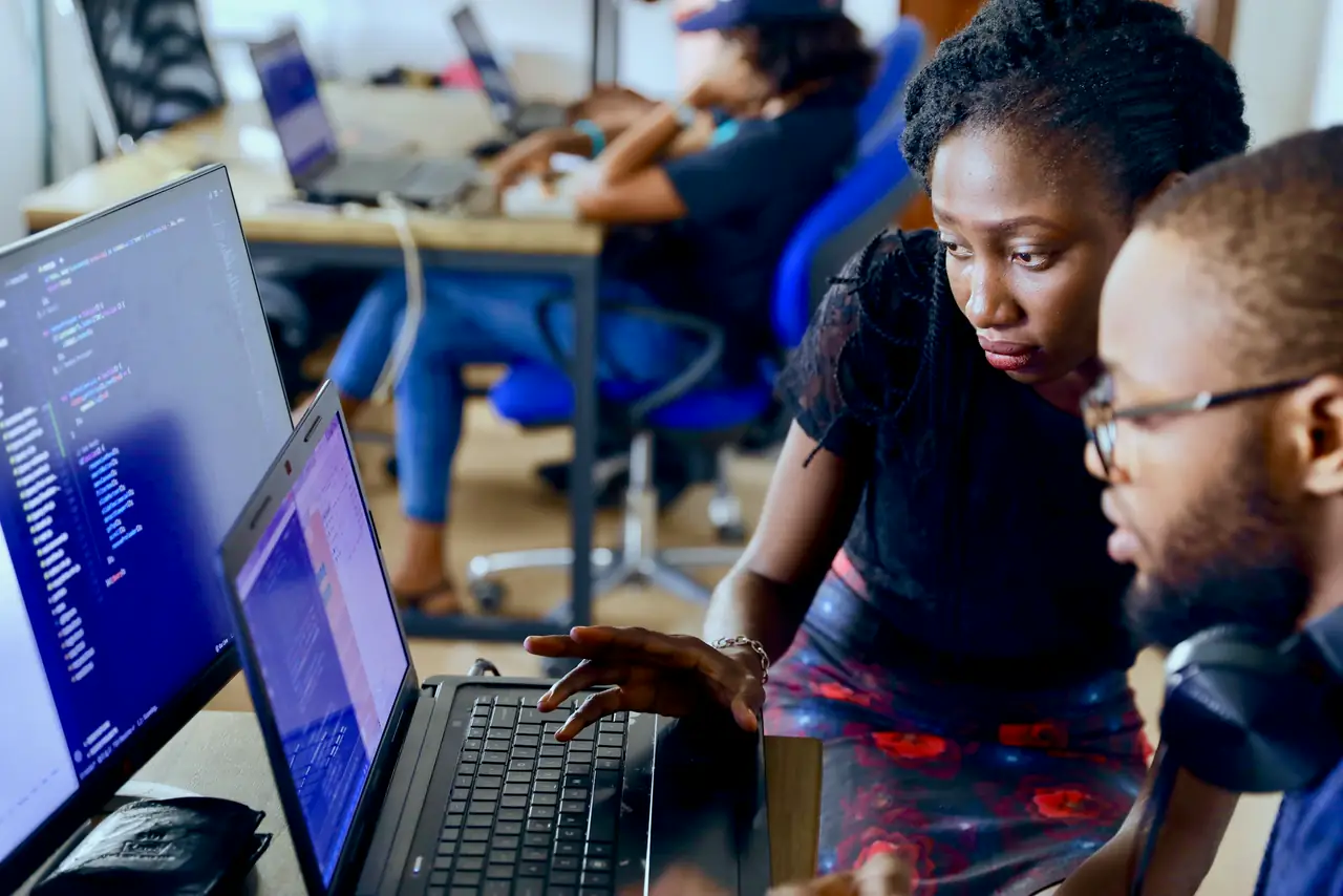 A Lagos tech team writing code together around a shared desk
